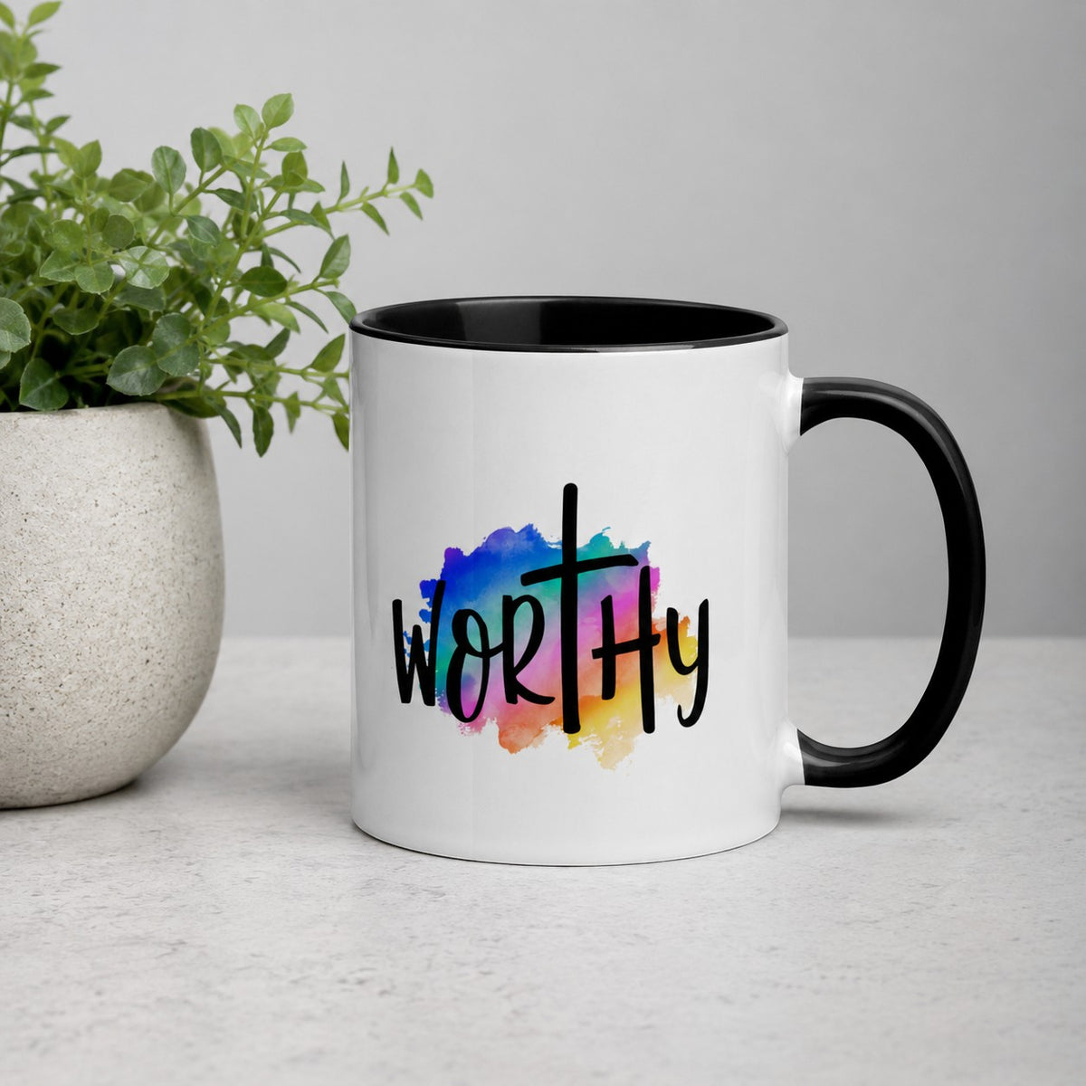 Brewtiful Sips Worthy ceramic mug with a black handle and colorful watercolor cross design on a white background.
